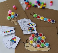 some crafting materials are laying out on the table with markers and buttons to make them look like snails