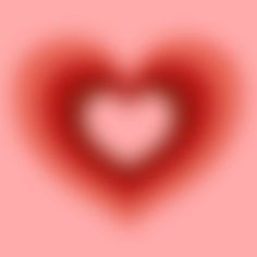 a blurry image of a red heart on a pink background