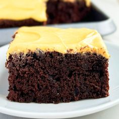 a piece of chocolate cake with yellow frosting