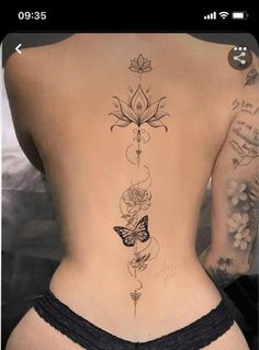 the back of a woman's body with tattoos on her stomach and flowers growing out of it