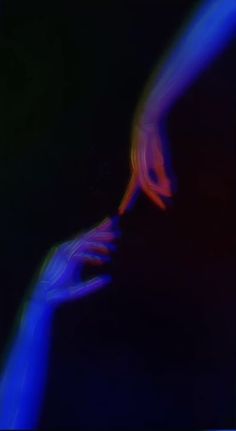 two hands touching each other in front of a black background with blue and red lights