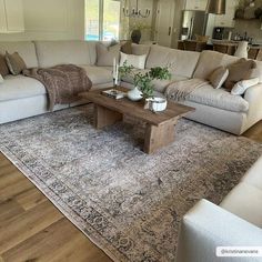 a living room filled with furniture and a large rug