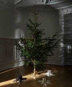 a small christmas tree sitting on top of a wooden floor