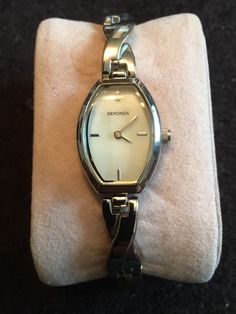 Vintage Sekonda silver ladies quartz watch The watch is in gorgeous condition brand new old stock  Dial glass and strap are in great condition  Lovely inexpensive watch great for that special night out  Made in the 2000s  Lovely small face  Made in the Japan  Chrome plated case White face  Silver hands  Quartz movement  New battery fitted  Original protection label to the back case  Size 2cm Width x 3cm high  Running well tested over a 24hr period Coach Watch, Small Face, Gold Cocktail, The 2000s, Watches Unique, Small Faces, White Face, Beautiful Watches, Silver Watch