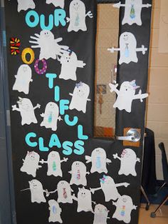 this door is decorated with ghost pictures and writing on it, which says our tf class