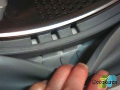 someone is removing something from the bottom of an appliance with their hands and fingers