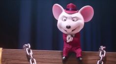 a cartoon mouse in a red suit and top hat standing on a wooden board with chains