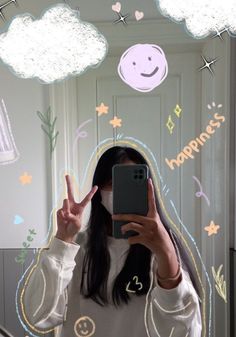 a woman taking a selfie in front of a mirror with the words happiness written on it