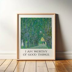 an art print with the words i am worthy of good things on it in front of a wood floor