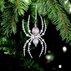 a spider ornament hanging from a christmas tree