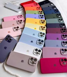 many different colored iphone cases are arranged on a white surface and one is open to show the back side