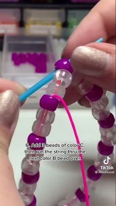 someone is doing something that looks like beads