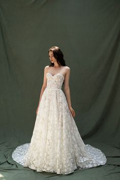 a woman in a wedding dress standing on a green background