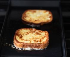 two pieces of toast sitting on top of an oven