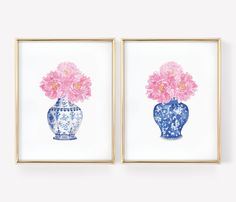 two blue and white vases with pink flowers in them are framed on the wall