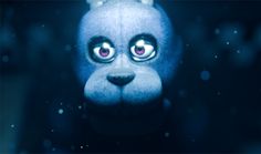 a blue stuffed animal with big eyes in the dark