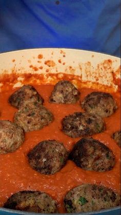 meatballs covered in tomato sauce in a pan