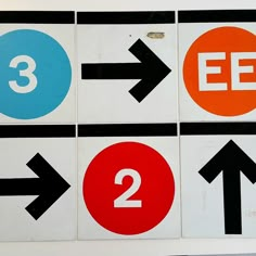 four different street signs with arrows pointing to the left and 3 on the right side