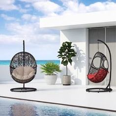 two hanging chairs next to a pool with a potted plant in the middle and an umbrella chair on top