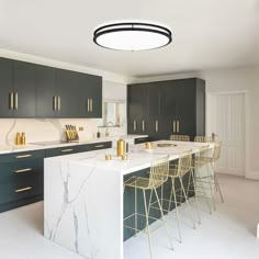 a kitchen with marble counter tops and bar stools