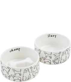 two white bowls with dogs on them and the words slurp written in black ink