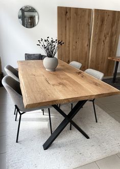 a wooden table with chairs around it