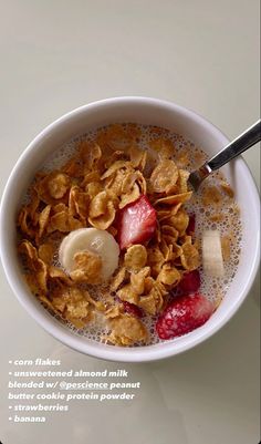 a bowl filled with cereal and fruit on top of a table