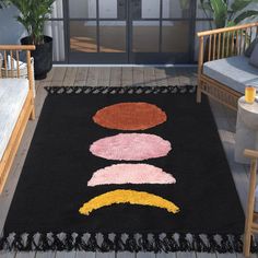 a black rug with different colored shapes on it