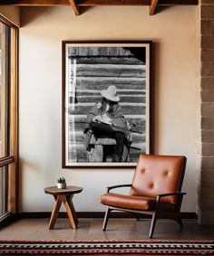 a cowboy sitting in a chair next to a window