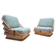 two chairs made out of bamboo with blue upholstered cushions and wood frames, one sitting on top of the other