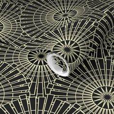 an artistic black and gold wallpaper with geometric design on it's surface,