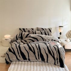 a zebra print comforter and pillows in a bedroom