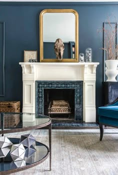 a living room filled with furniture and a fire place in front of a large mirror