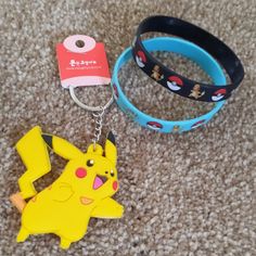 two rubber bracelets with pokemon characters on them, one is blue and the other has a yellow pikachu