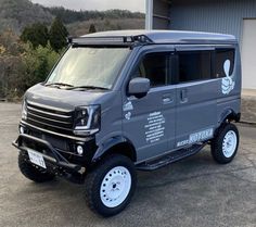 a grey van parked in front of a building