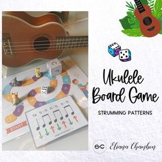 the ukulele board game is sitting on top of a table next to other items