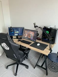 a computer desk with two monitors and a laptop