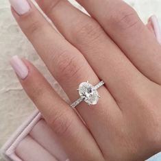 a woman's hand with a diamond ring on it