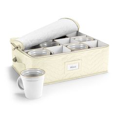 a white cup and some glasses in a case