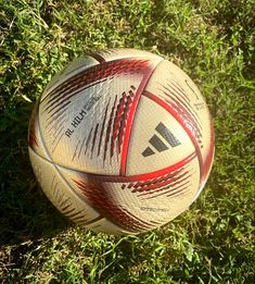 a soccer ball laying on the ground in the grass