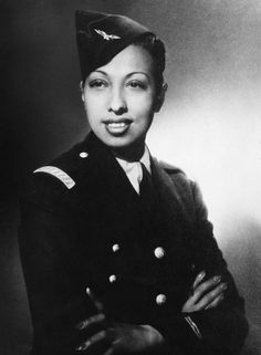 a black and white photo of a woman in uniform