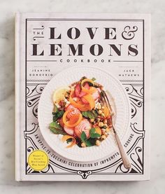 the love and lemons cookbook on a marble surface with a fork in it