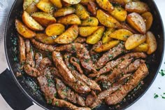 steak and potatoes in a skillet with herbs