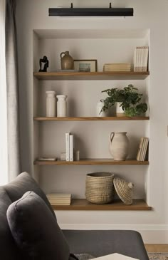 a living room filled with furniture and shelves