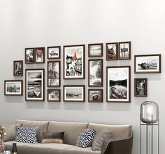 a living room filled with furniture and framed pictures on the wall above it's coffee table