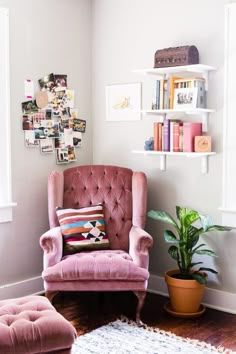 a pink chair and ottoman in a small room