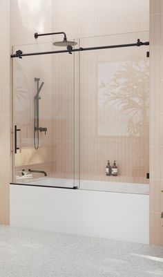 a bath tub sitting next to a shower with a glass door on the back wall