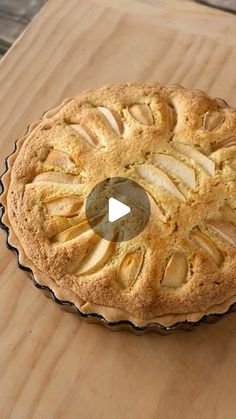 an apple pie sitting on top of a wooden table