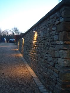 a stone wall that has lights on it