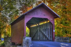 an old covered bridge in the fall